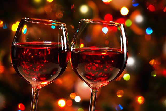 Crystal glasses of wine on the background of Christmas lights